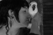 Black and white photo of woman and parrot