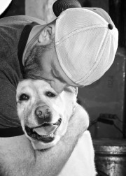 Black and white photography of man kissing lab